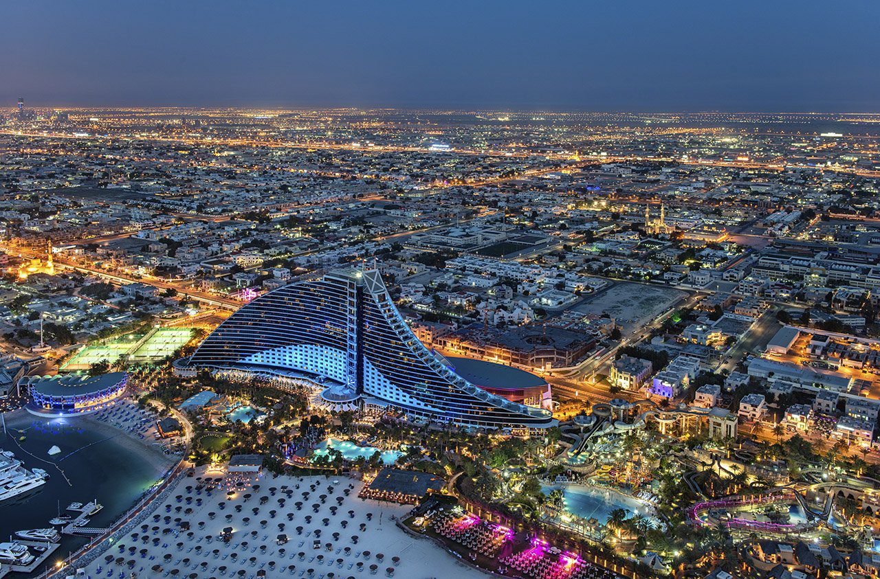 View of Jumeirah beach hotel Aerial night view of the Jumeirah Beach Hotel and surrounding Dubai coastline.
