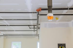 Automatic fire sprinkler system install on pipe ceiling background