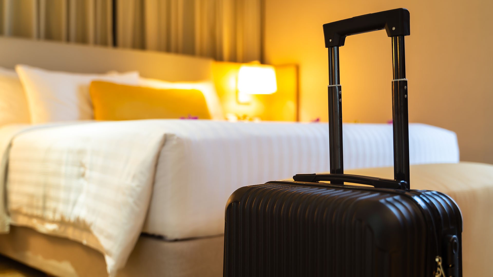 Hotel guest room with suitcase highlighting the importance of early water leak detection in hotels in Dubai