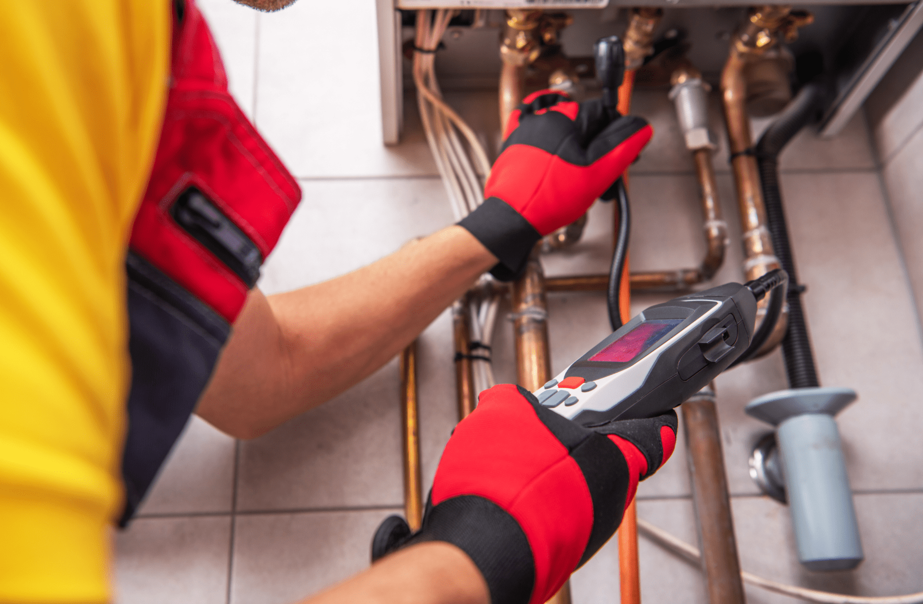 Technician inspecting household pipework