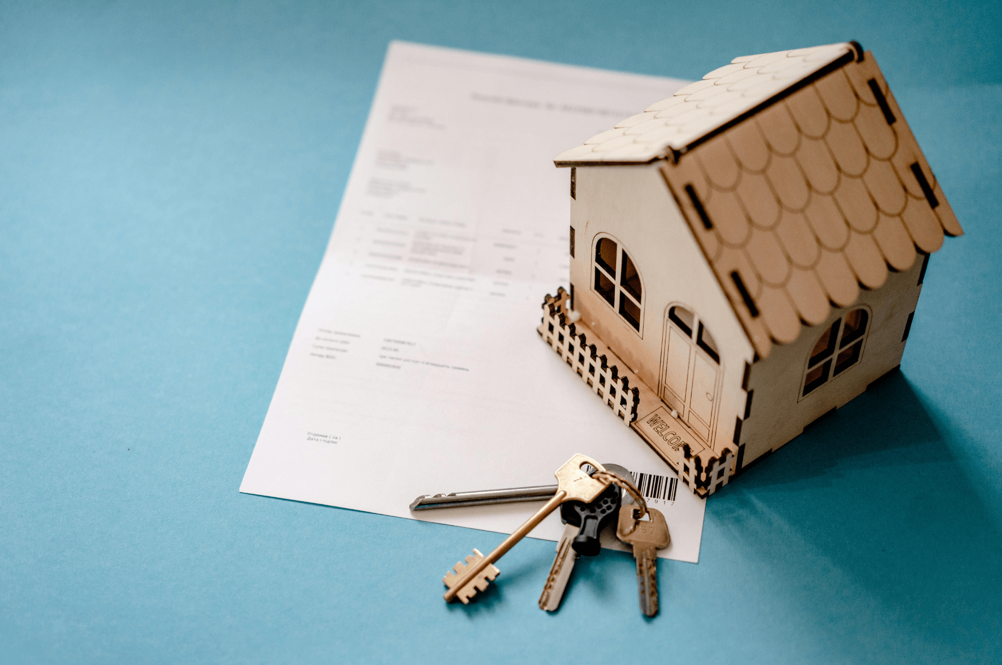 house model with keys and contract for property handover inspection in Dubai